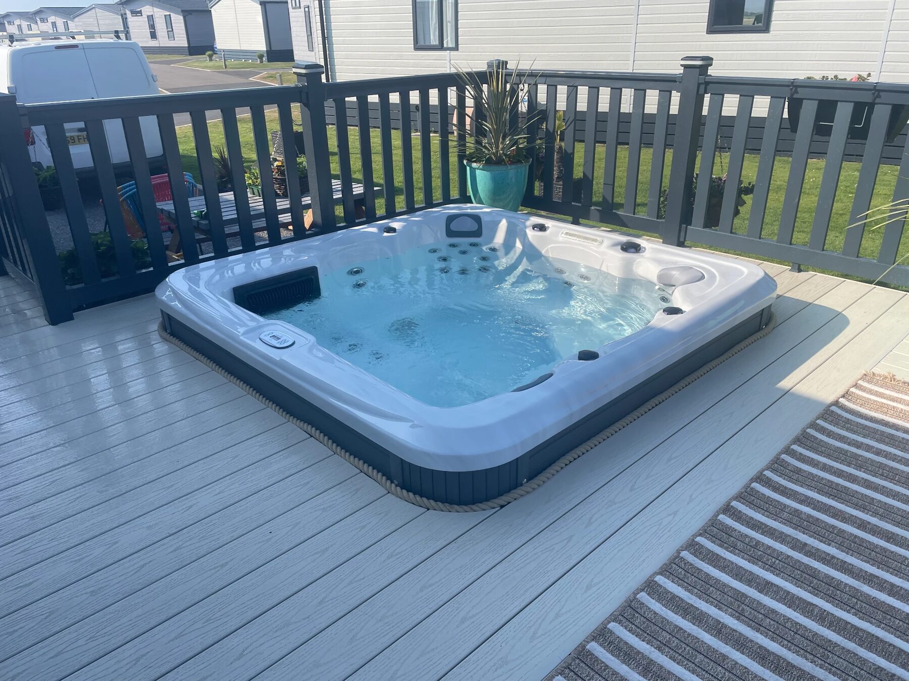Hot tub installed flush into composite decking at a coastal property