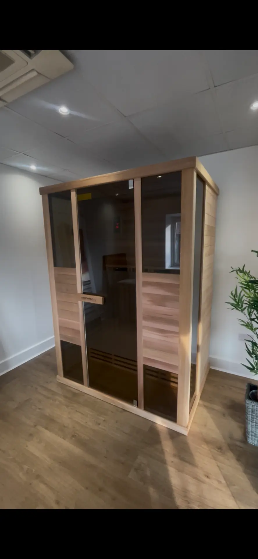 Glass-fronted sauna cabin on display in the StarLuxe showroom