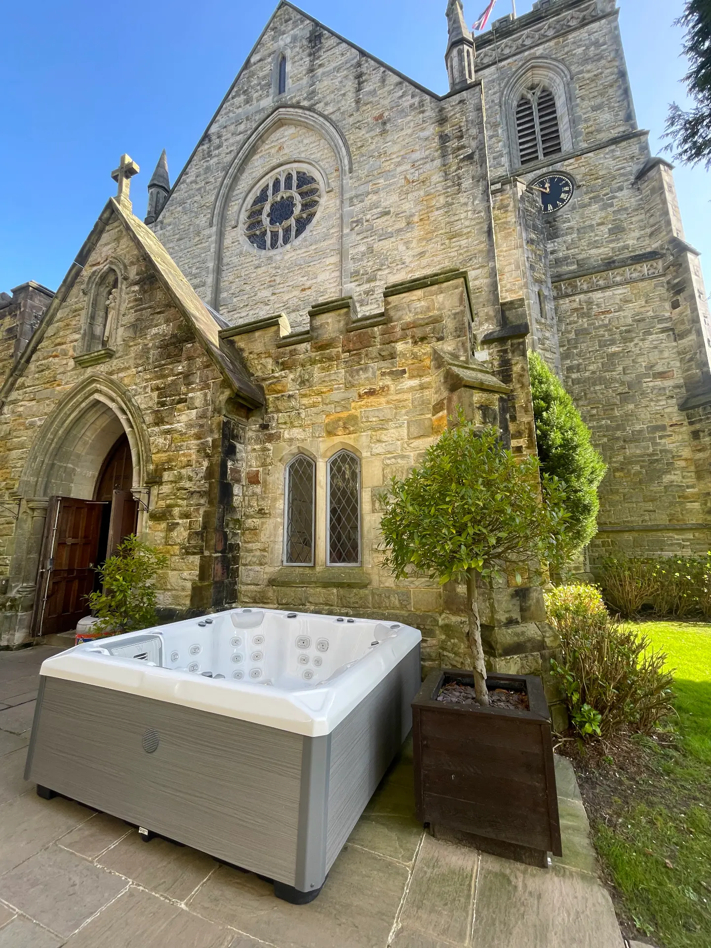 Hot tub positioned beside a converted stone church
