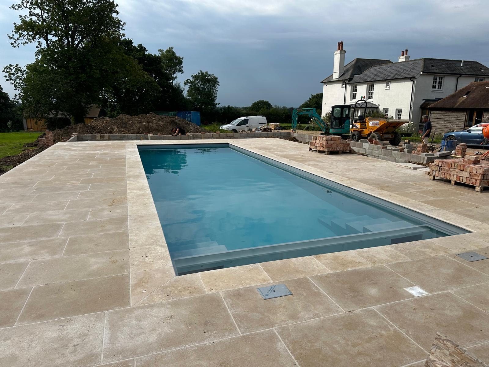 Rectangular pool with a wide natural stone surround