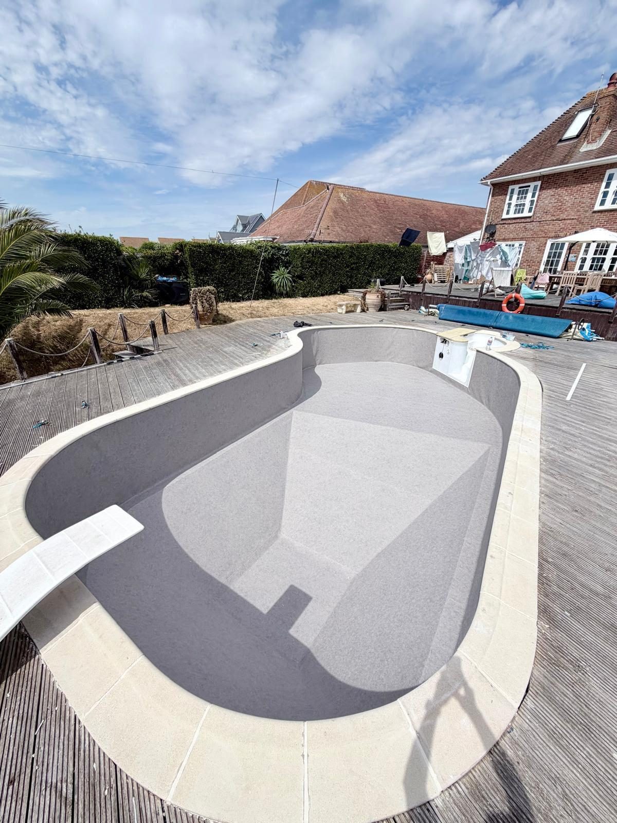 The same oval pool filled and finished after renovation