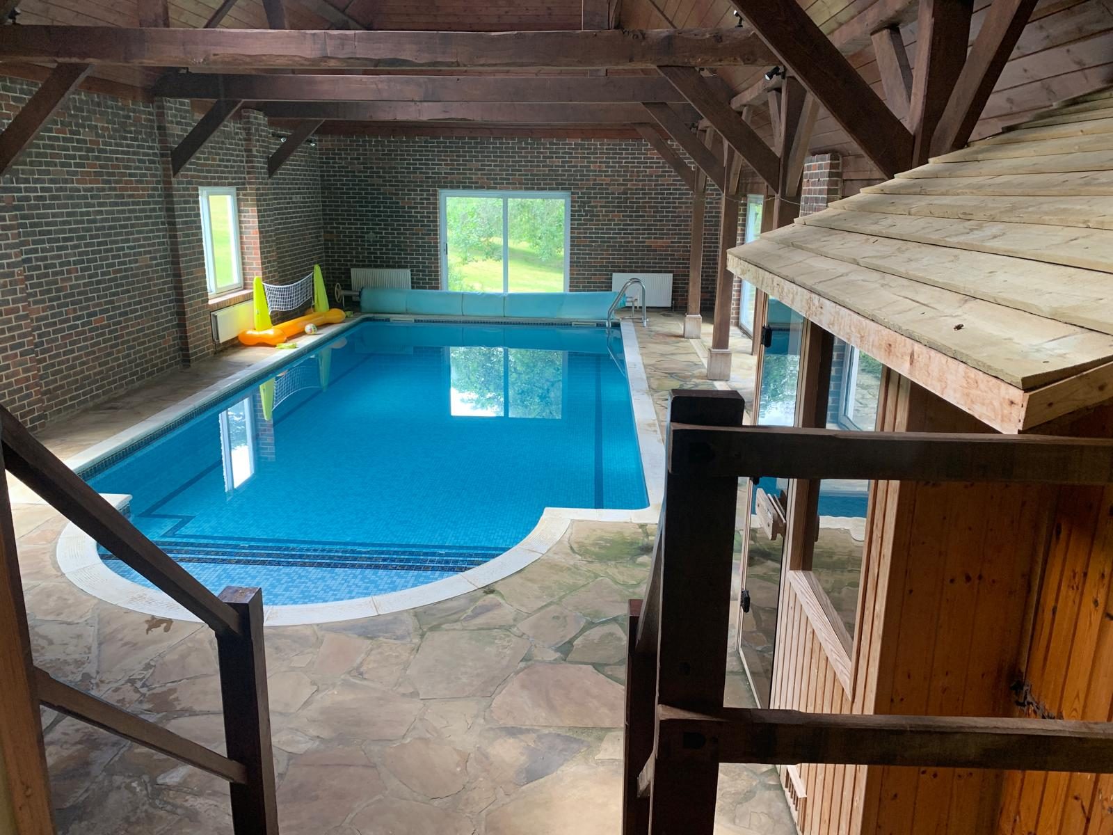 Indoor pool beneath a timber-framed roof