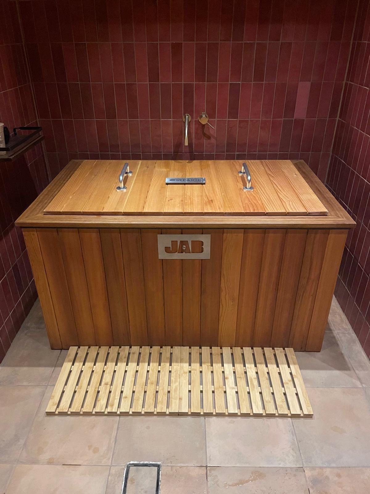 Rectangular wooden ice bath installed indoors