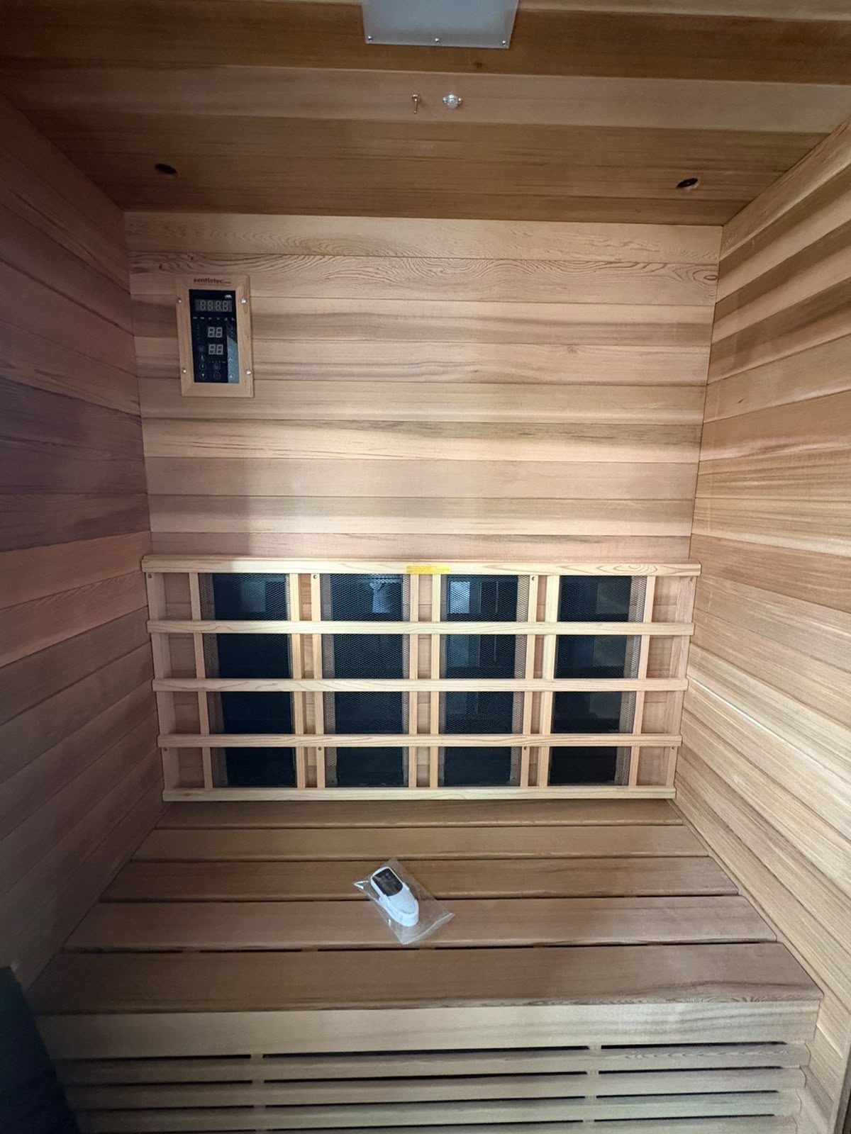 Sauna interior with timber benches and infrared heating panels