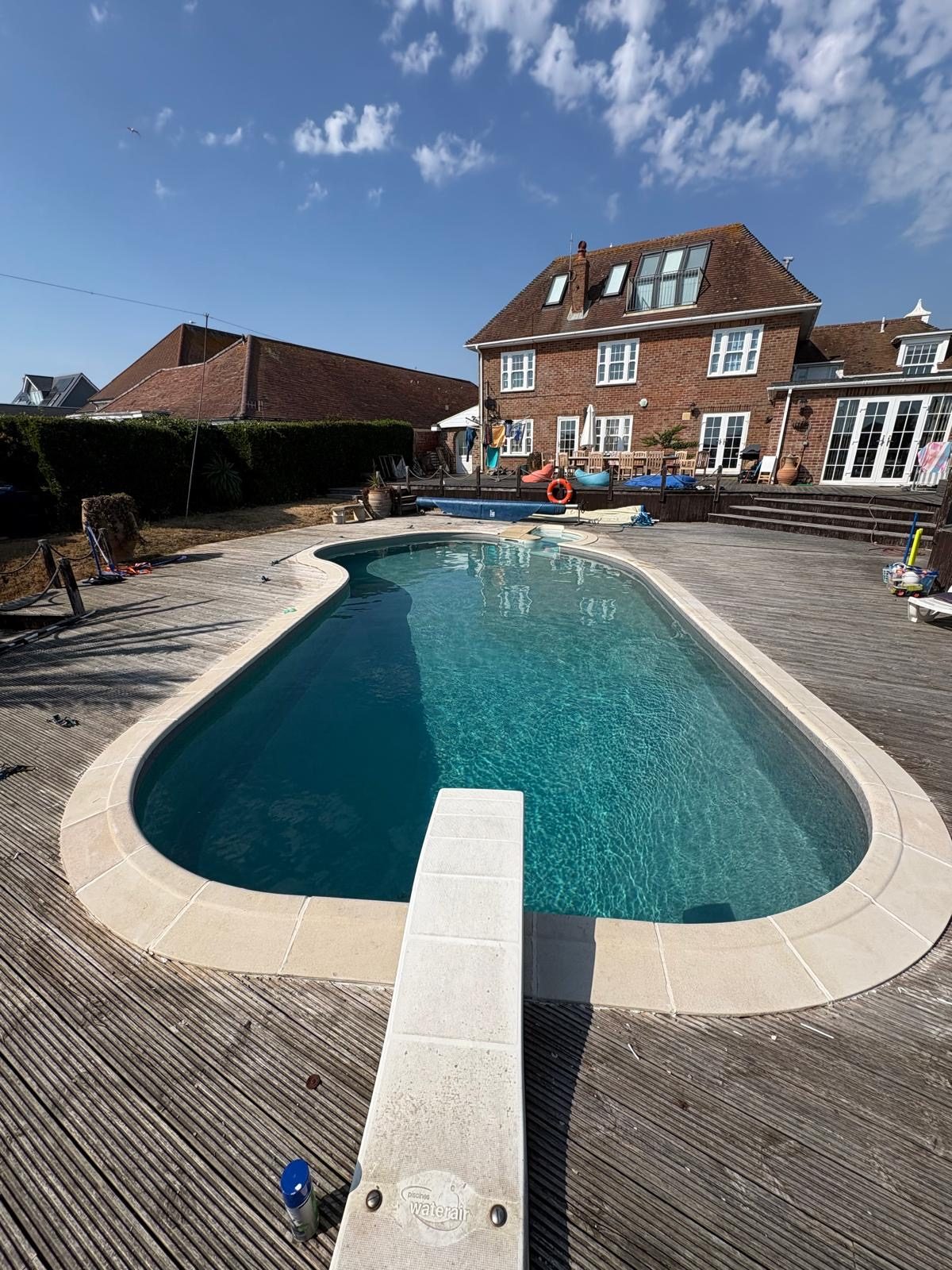Oval pool with a pale interior ready for renovation